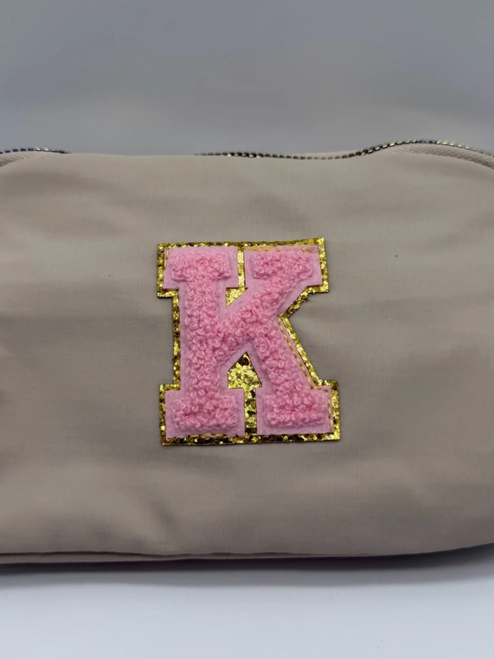 Beige Pouch with Pink 'K' Patch and Gold Trim